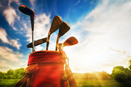 golf clubs at sunset - blog